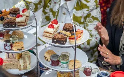 Afternoon tea with pastries and scones on a London Christmas Lights bus tour.