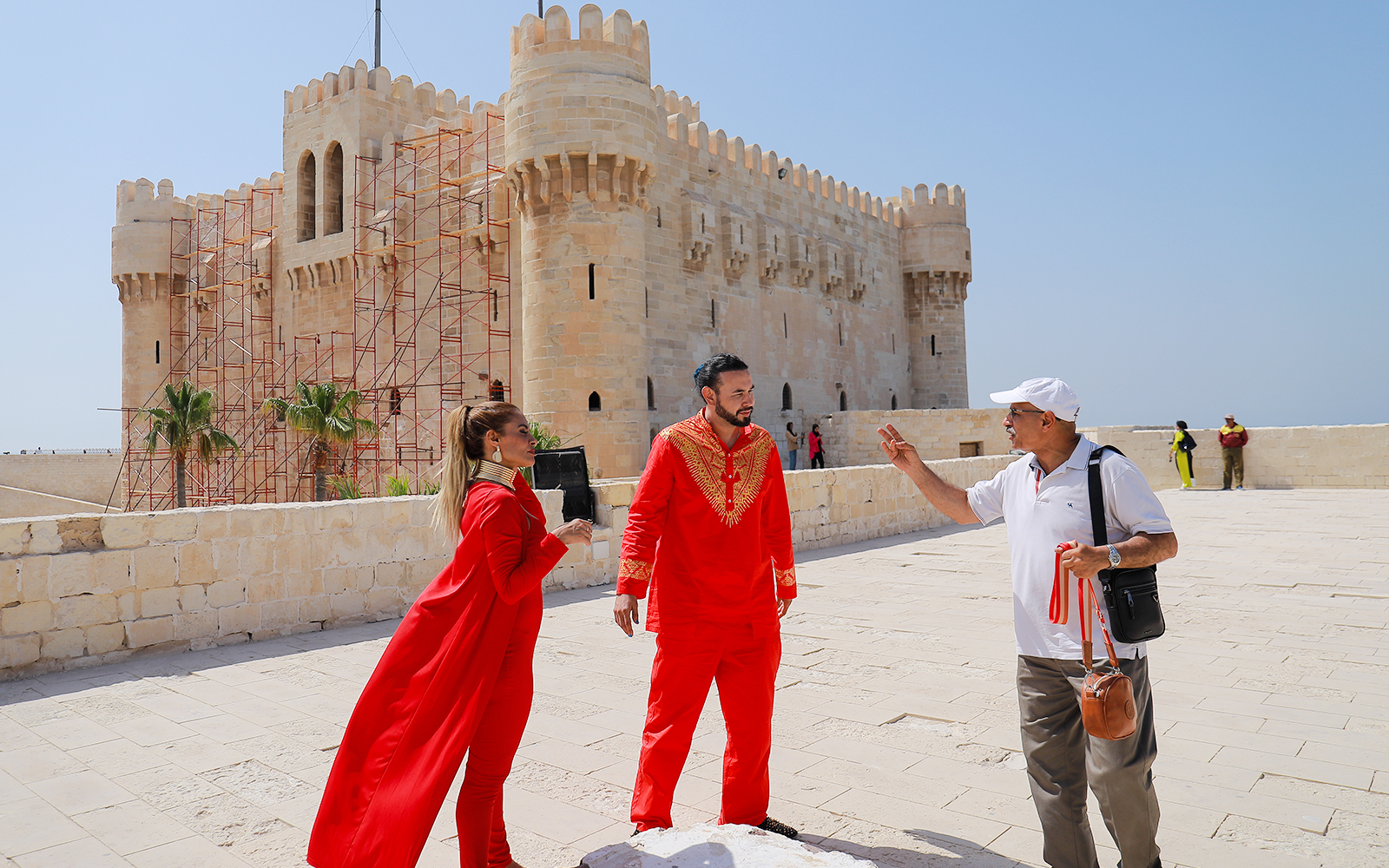 Tourists in traditional attire at the Citadel of Qaitbay, Alexandria, during a full day tour from Cairo.