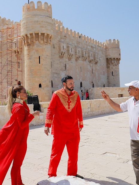 Tourists in traditional attire at the Citadel of Qaitbay, Alexandria, during a full day tour from Cairo.