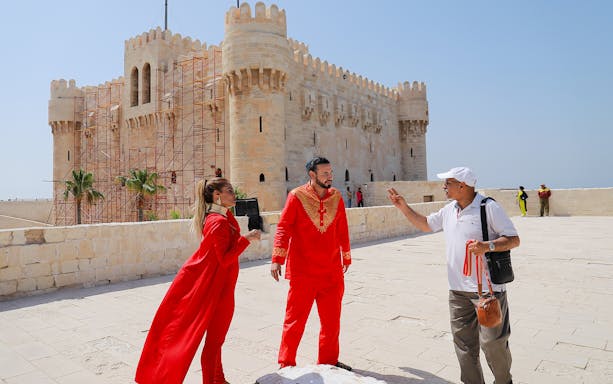 Tourists in traditional attire at the Citadel of Qaitbay, Alexandria, during a full day tour from Cairo.