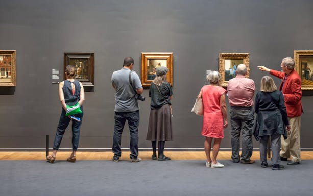Guests viewing paintings at the Rijksmuseum in Amsterdam.
