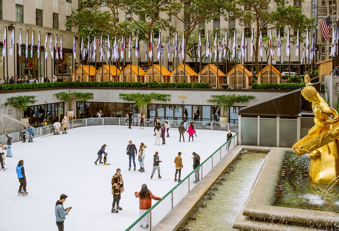 Tourists ice skating at The Rink, Rockefeller Center, New York City.
