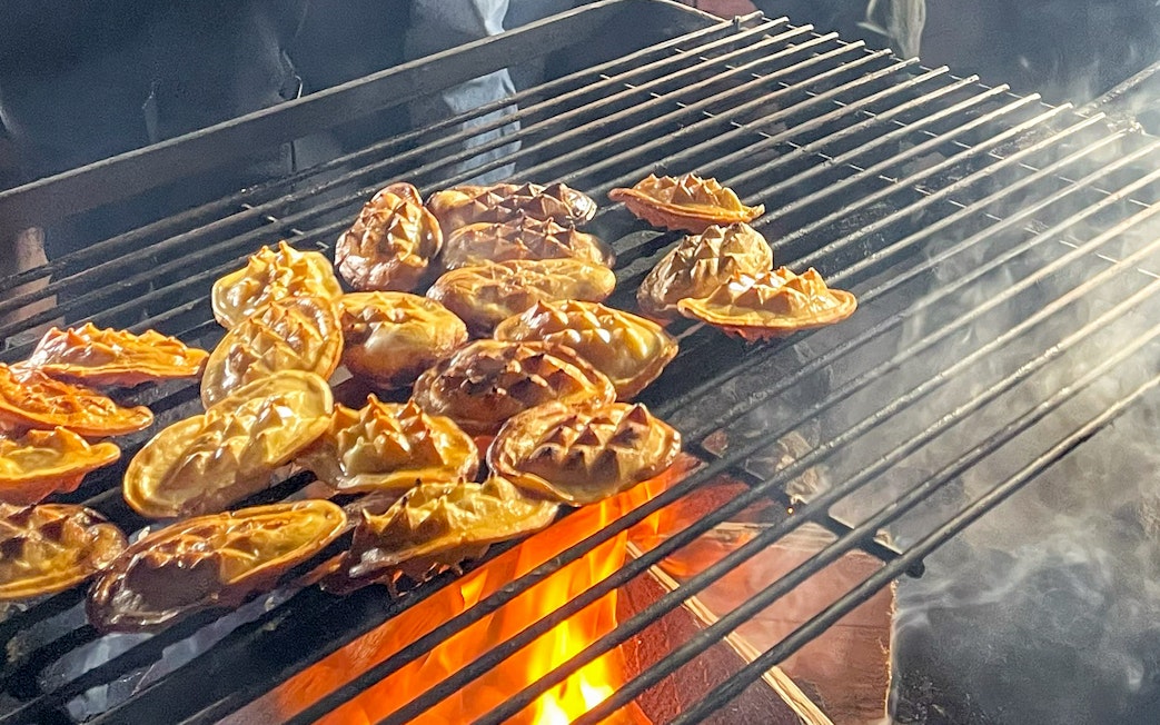 Traditional Polish smoked cheese grilling over open flames.