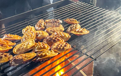 Traditional Polish smoked cheese grilling over open flames.