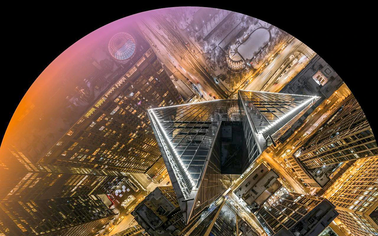 Aerial view of Chicago skyscrapers at night during Flyover Chicago experience.