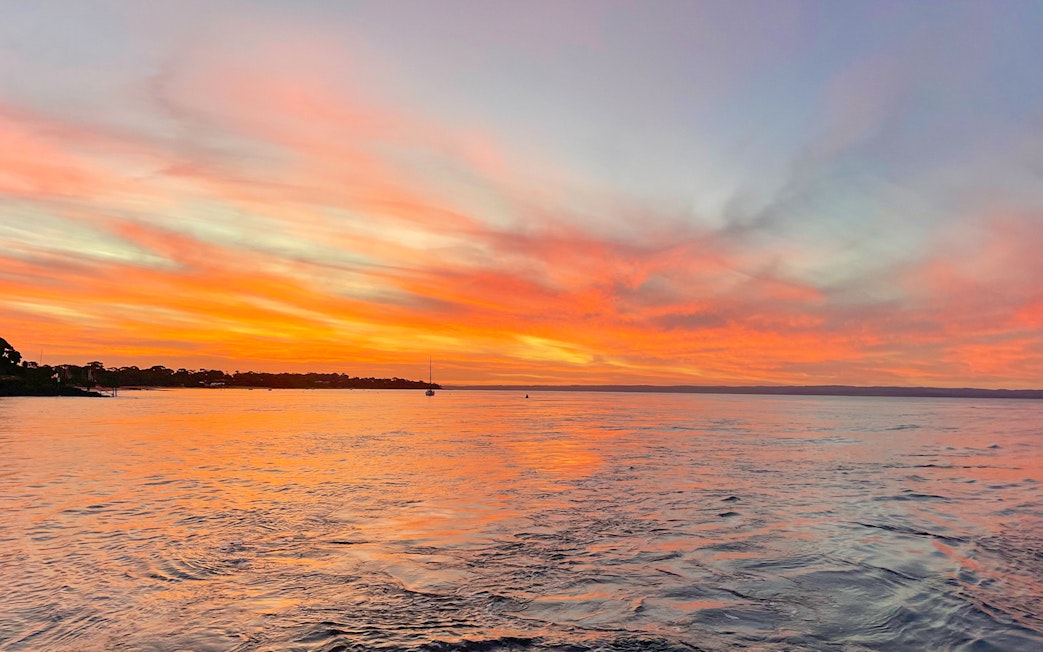 Sunset over water during a sightseeing cruise at Phillip Island.