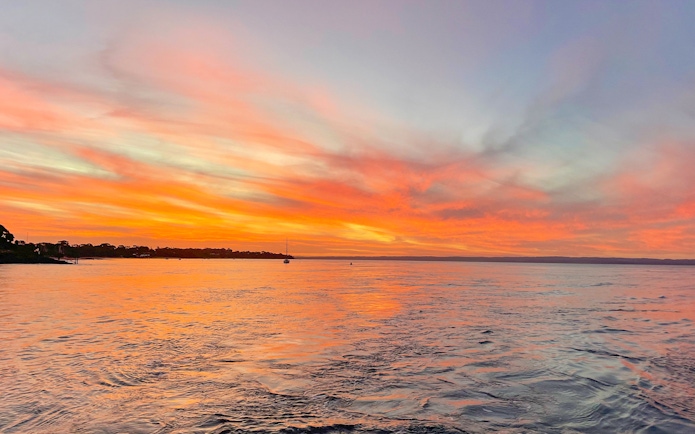 Sunset over water during a sightseeing cruise at Phillip Island.