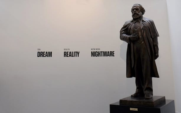 Statue of Karl Marx with "Dream, Reality, Nightmare" text at Museum of Communism, Prague.
