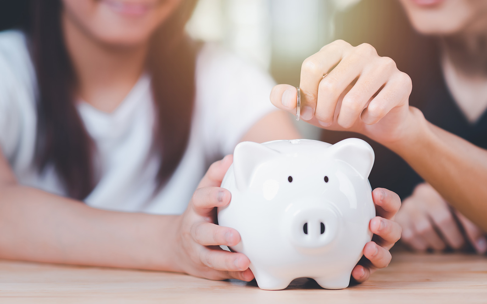 Tourists exploring Amsterdam with Hop On Hop Off Bus with a focus on budget-friendly travel options.