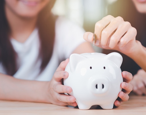 Tourists exploring Amsterdam with Hop On Hop Off Bus with a focus on budget-friendly travel options.
