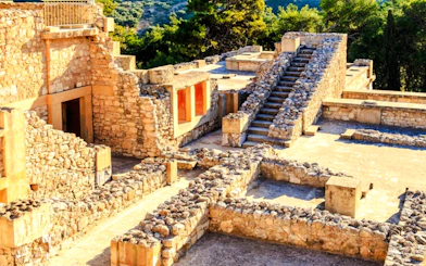 Phaistos Palace ruins with stone walls and steps, Crete archaeological site.