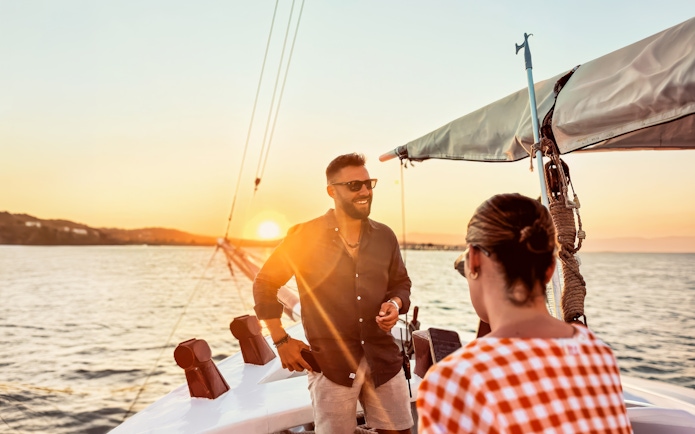 Guest enjoying sunset cruise on a boat in Corfu, Greece.