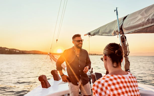 Guest enjoying sunset cruise on a boat in Corfu, Greece.
