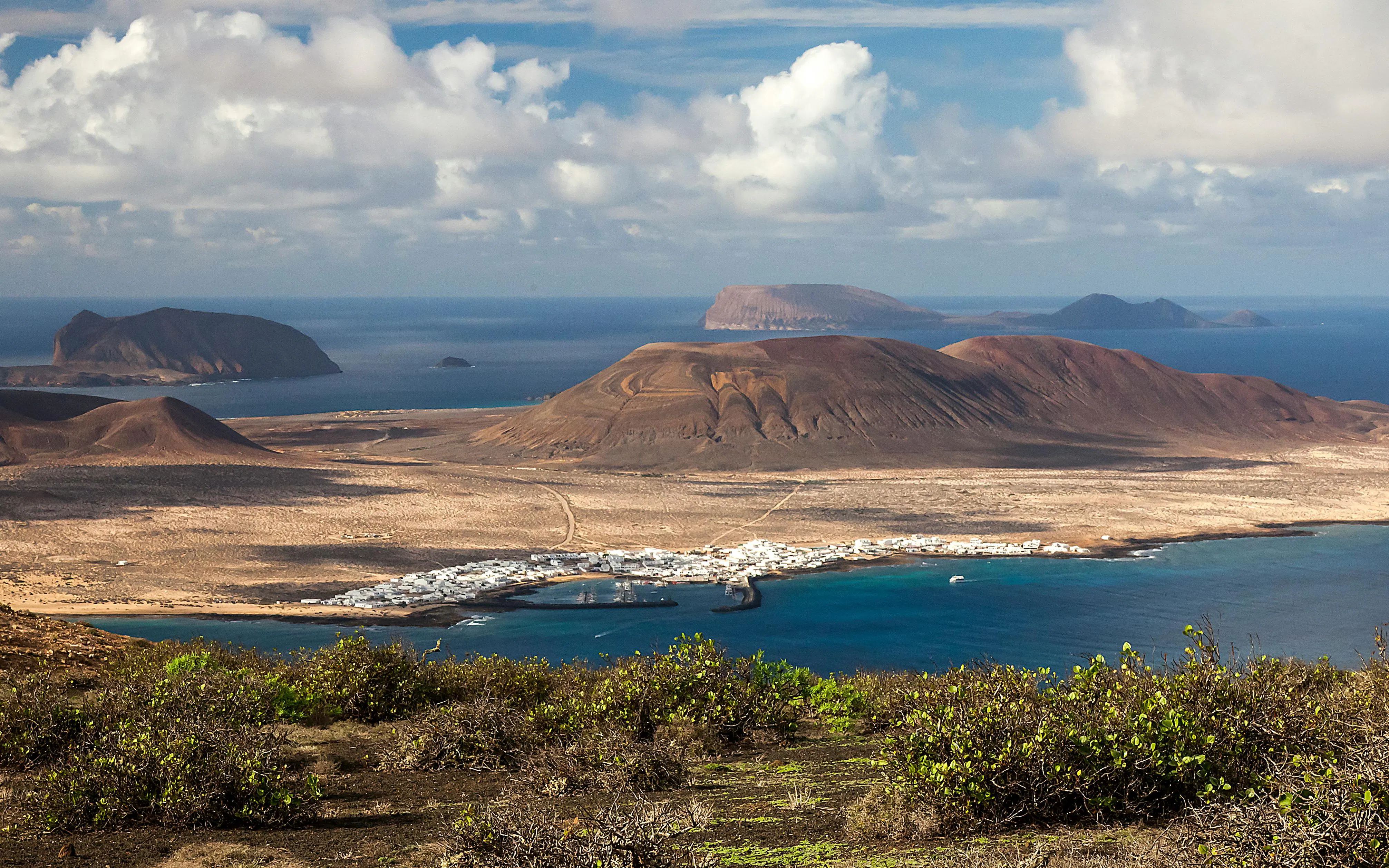 La Graciosa island landscape with volcanic hills and coastal village, Canary Islands.