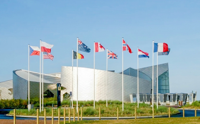 Flags outside the Juno Beach Centre in Normandy, France, part of the D-Day tour from Paris.