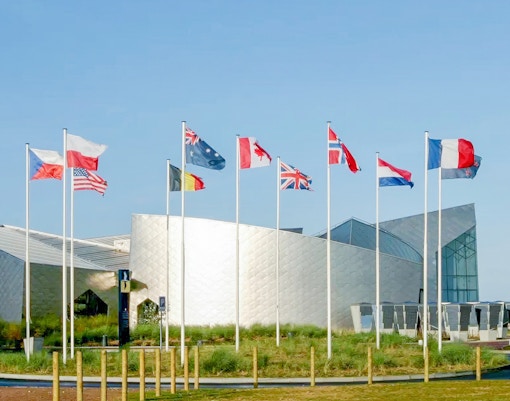 Flags outside the Juno Beach Centre in Normandy, France, part of the D-Day tour from Paris.