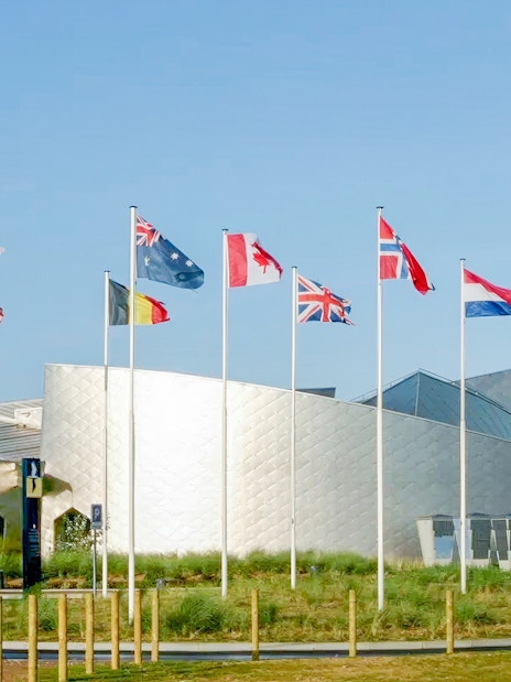 Flags outside the Juno Beach Centre in Normandy, France, part of the D-Day tour from Paris.