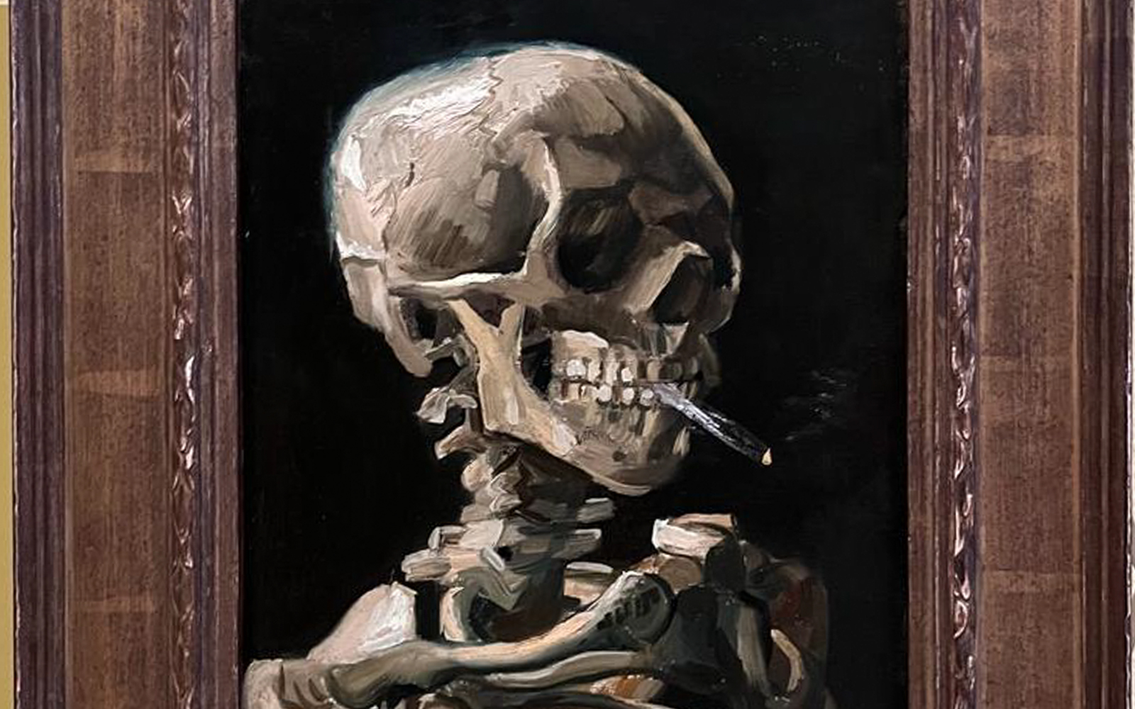 head of a skeleton with a burning cigarette at the van gogh museum
