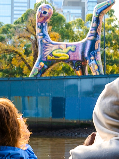 Passengers view colorful sculpture from Melbourne Yarra River cruise.