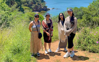 Guests enjoying a scenic walk on Princess Island with a view of the sea and lush greenery.