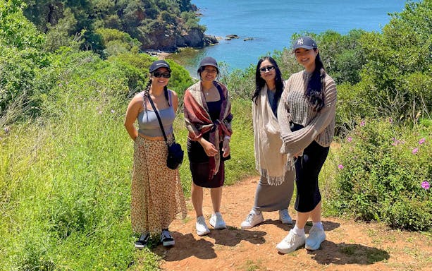 Guests enjoying a scenic walk on Princess Island with a view of the sea and lush greenery.