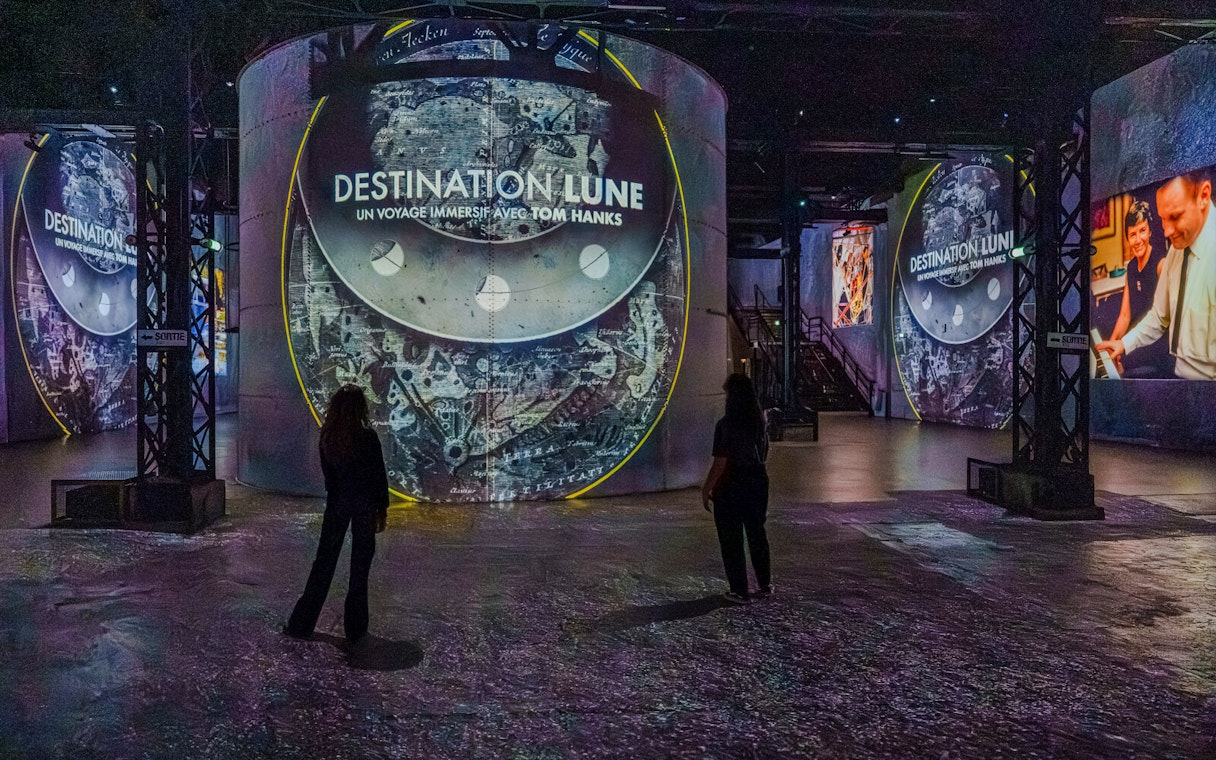 Moonwalkers Exhibition at Atelier des Lumières with immersive lunar projections.