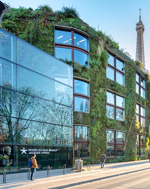 Musée du Quai Branly exterior with vertical garden and Eiffel Tower in Paris.
