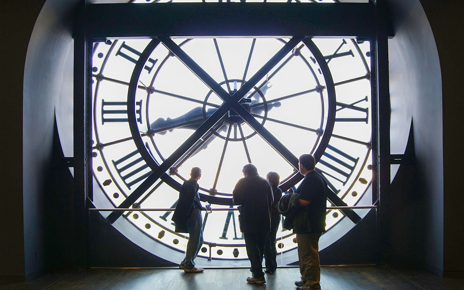 Visitors exploring art at Orsay Museum, Paris, during a guided tour focused on Impressionist masterpieces.