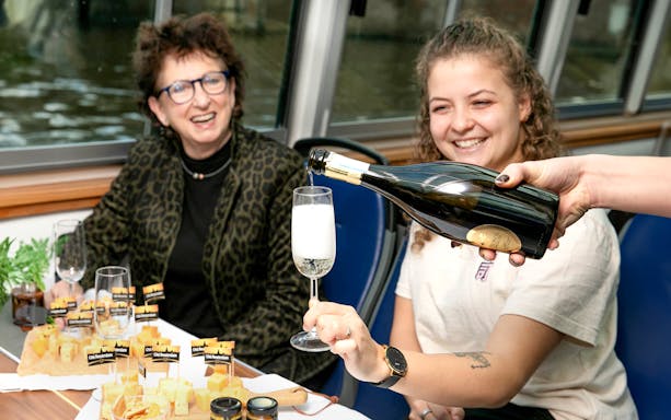 Pouring sparkling wine on a cheese and wine cruise in Haarlem.