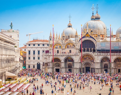 St. Mark's Basilica exterior with ornate domes and arches in Venice, Italy.