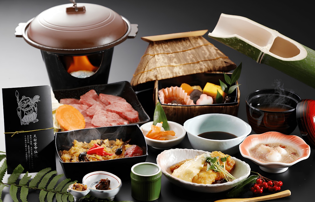 Osechi traditional Japanese food with assorted dishes, including grilled meat, vegetables, and rice, in a festive setting.