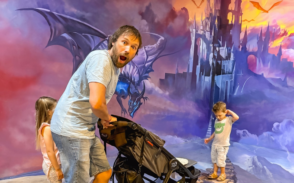 Family enjoying dragon-themed trick art at ArtVo Melbourne.