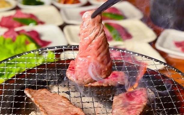 Grilling Wagyu beef slices at Nikusen Tonya restaurant.