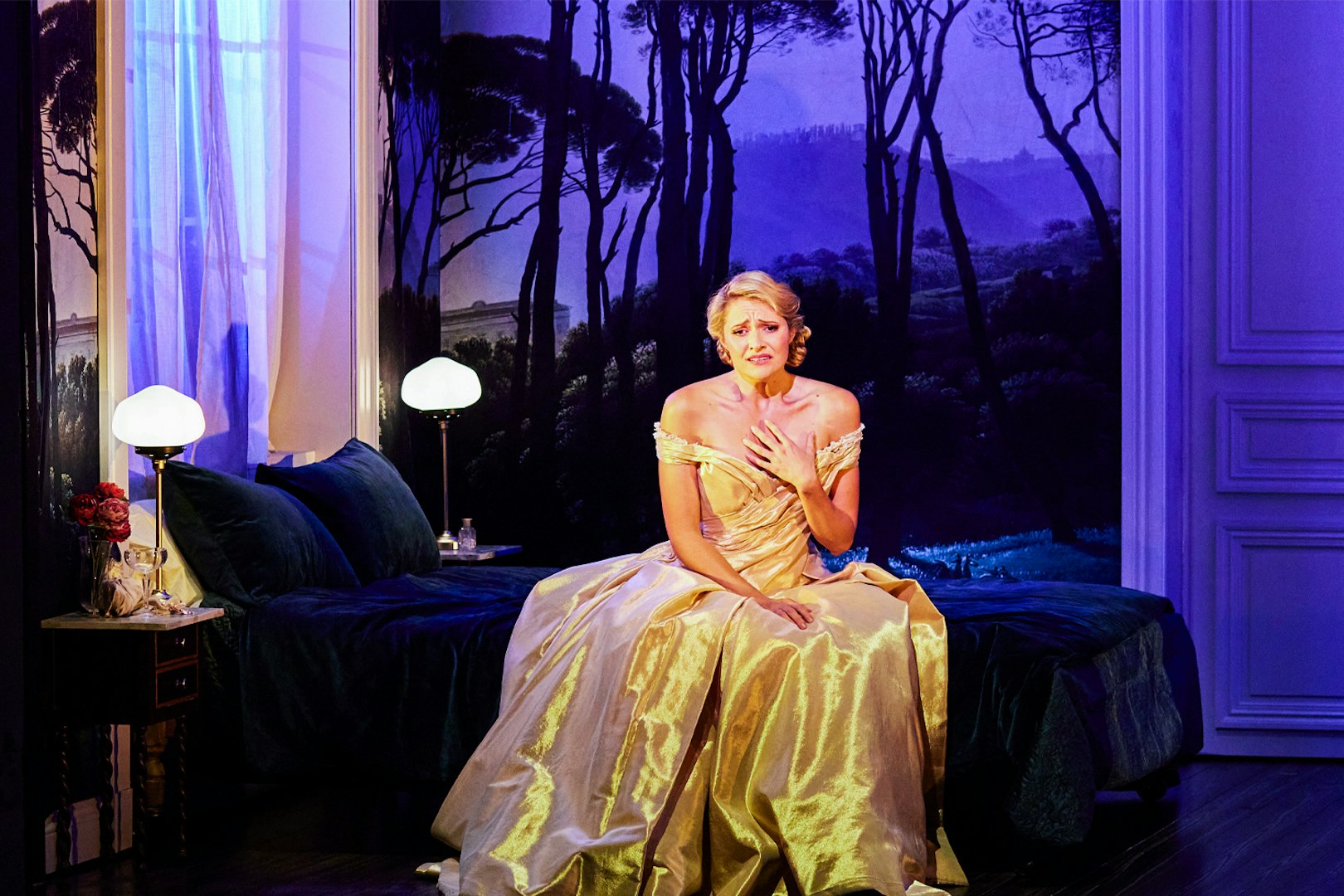 Performer in a golden gown on stage during La Traviata at Sydney Opera House.