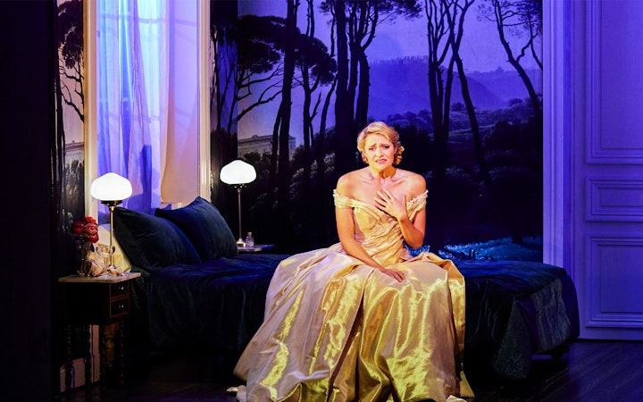 Performer in a golden gown on stage during La Traviata at Sydney Opera House.
