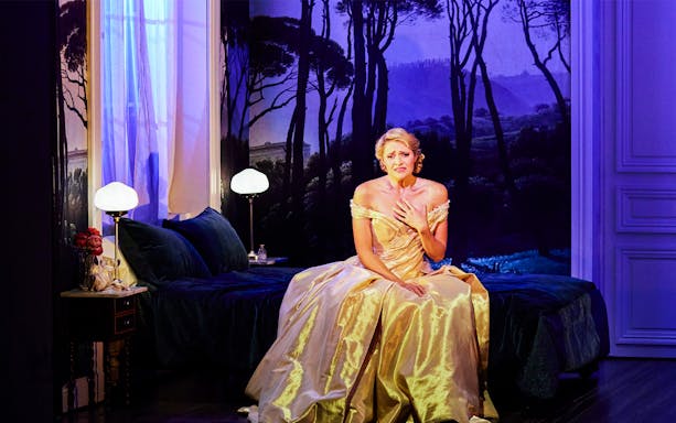 Performer in a golden gown on stage during La Traviata at Sydney Opera House.