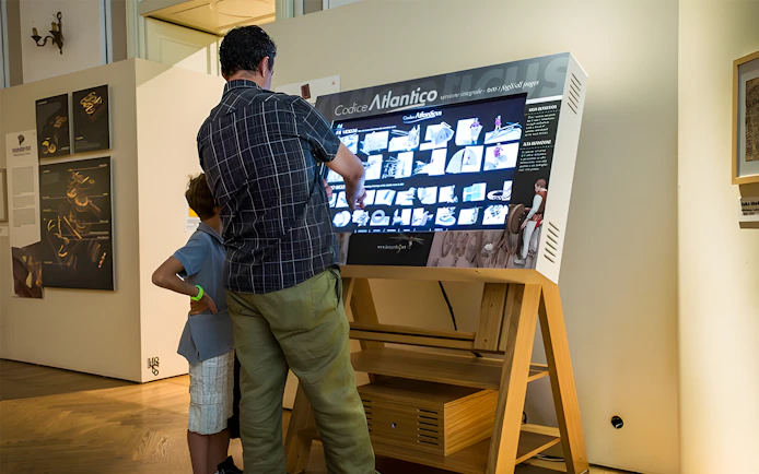 Visitors interacting with a digital display at Leonardo3 Museum, Milan.