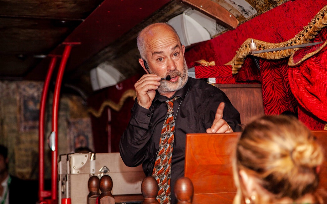 Tour guide narrating on the Dublin Ghostbus Tour.