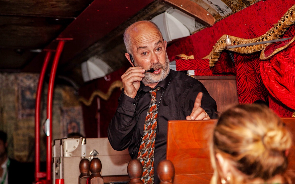 Tour guide narrating on the Dublin Ghostbus Tour.