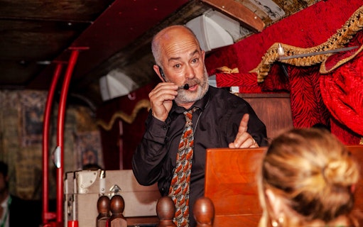 Tour guide narrating on the Dublin Ghostbus Tour.