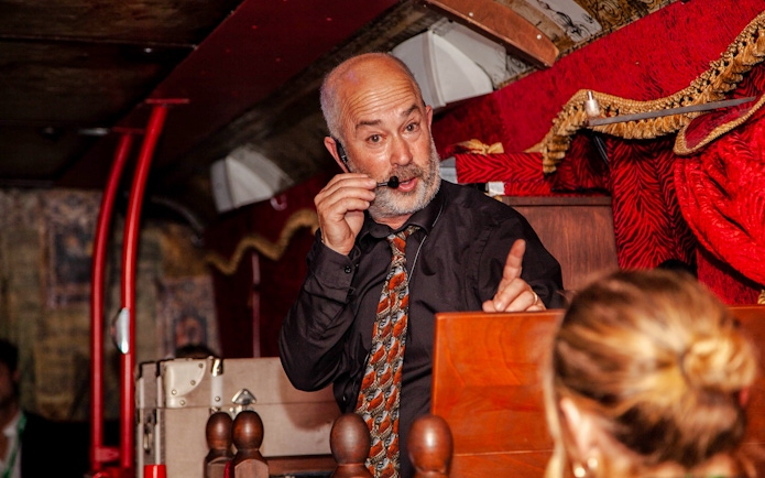 Tour guide narrating on the Dublin Ghostbus Tour.