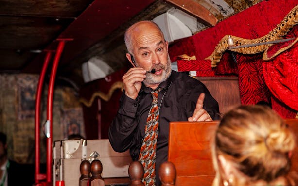 Tour guide narrating on the Dublin Ghostbus Tour.