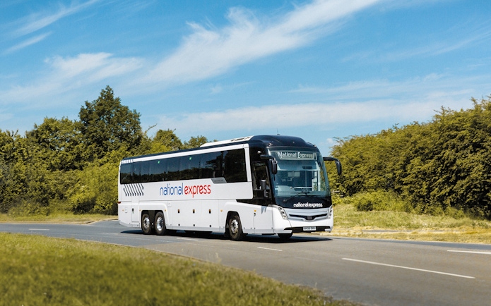 National Express bus on a road, offering airport transfer service.