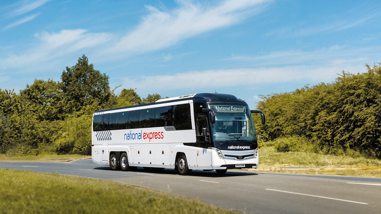National Express bus on a road, offering airport transfer service.