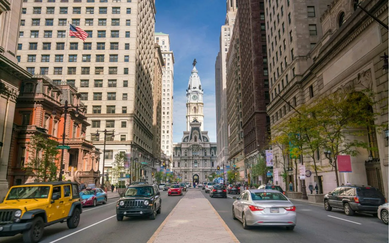 Philadelphia City Hall viewed from a busy street in Old Town, part of a self-guided exploration game.