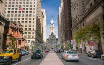 Philadelphia City Hall viewed from a busy street in Old Town, part of a self-guided exploration game.