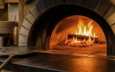 Wood-fired oven used in pasta and tiramisu cooking class, Florence walking tour.