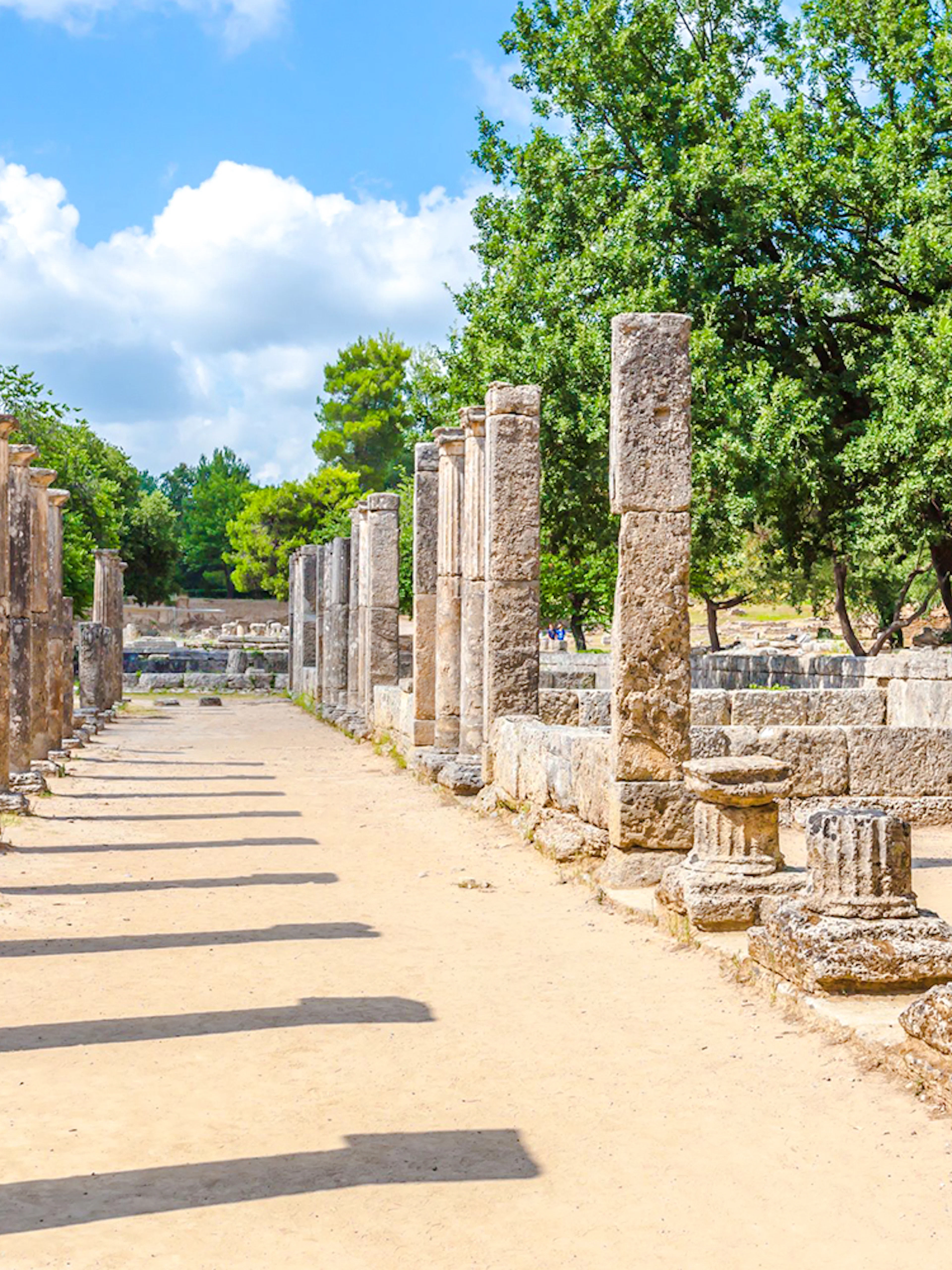 Ancient stone columns at the archaeological site of Ancient Olympia, Greece.
