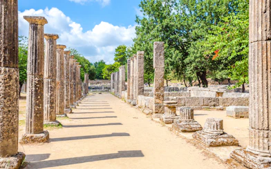 Ancient stone columns at the archaeological site of Ancient Olympia, Greece.