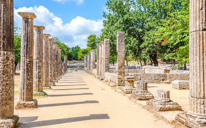 Ancient stone columns at the archaeological site of Ancient Olympia, Greece.